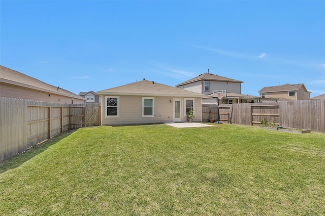 rear view of house featuring a patio, a fenced backyard, and a lawn