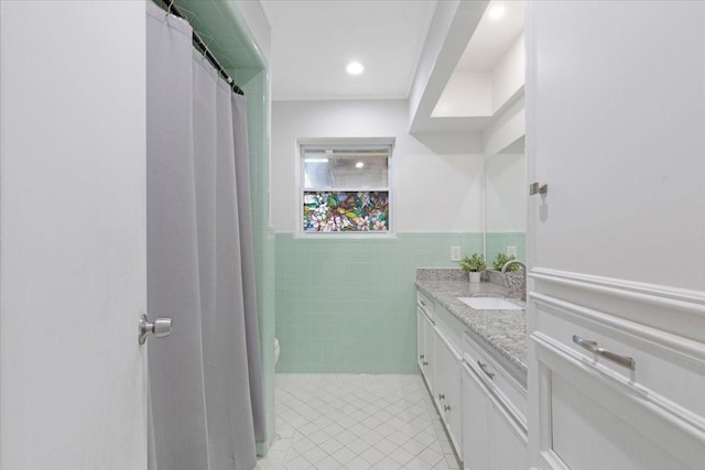 1004 Country Club Dr, Richmond, TX 77469 - full bath with vanity, tile patterned floors, toilet, a wainscoted wall, and tile walls