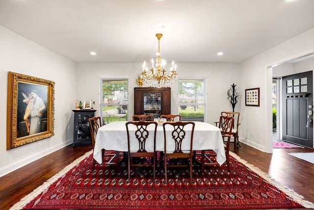 dining area with a chandelier, wood finished floors, and a healthy amount of sunlight