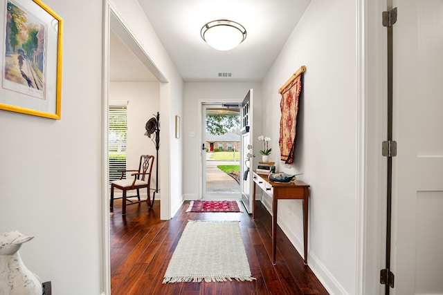 entryway featuring dark wood-type flooring, baseboards, and visible vents