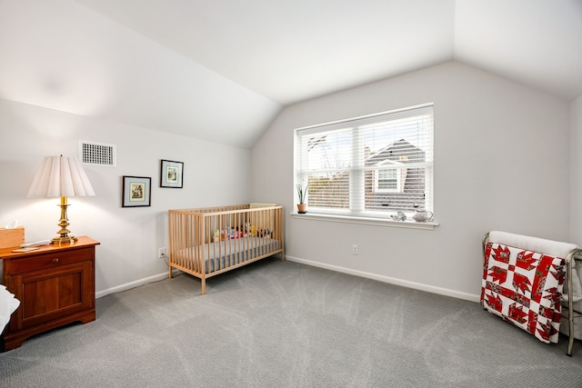carpeted bedroom featuring baseboards, vaulted ceiling, and visible vents