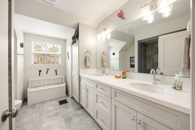 full bathroom with double vanity, visible vents, and a sink