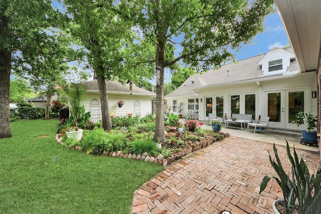 back of house featuring french doors, a patio, and a lawn
