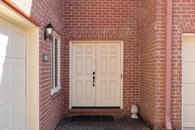 entrance to property featuring brick siding