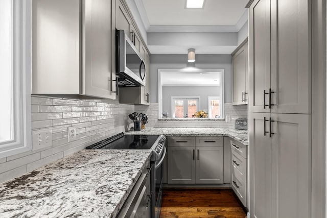 kitchen with gray cabinets, tasteful backsplash, appliances with stainless steel finishes, and crown molding