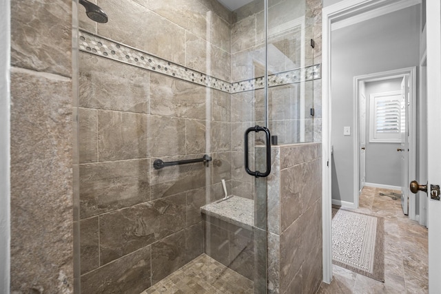 full bathroom with baseboards and a stall shower