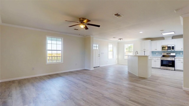 kitchen with open floor plan, visible vents, ornamental molding, and appliances with stainless steel finishes
