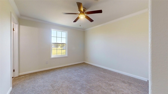 carpeted empty room featuring crown molding, ceiling fan, and baseboards