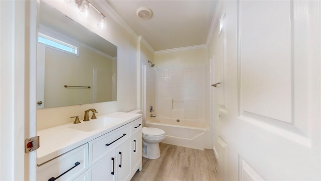 full bath featuring ornamental molding, toilet, bathtub / shower combination, vanity, and wood finished floors