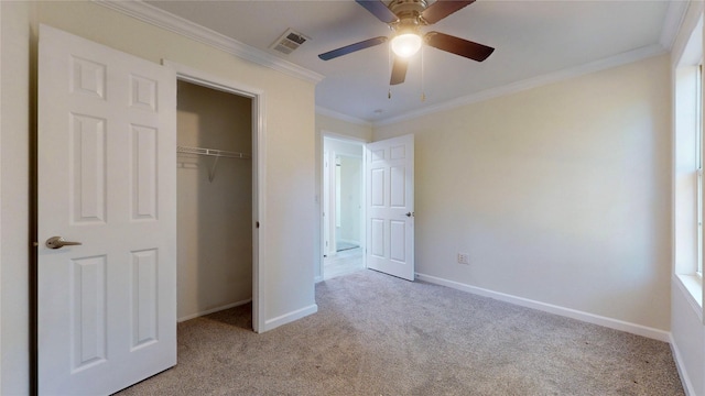unfurnished bedroom with crown molding, visible vents, baseboards, and carpet