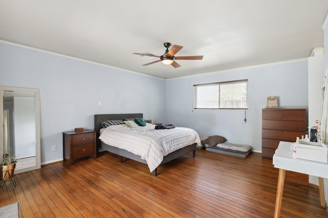 bedroom featuring ornamental molding, hardwood / wood-style flooring, and ceiling fan