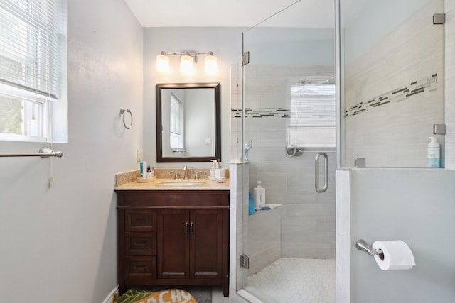 bathroom with a stall shower and vanity