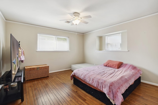 bedroom with baseboards, ornamental molding, and hardwood / wood-style floors