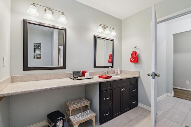 full bathroom featuring vanity and baseboards