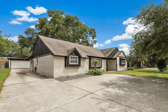 ranch-style house featuring board and batten siding, a garage, brick siding, an outdoor structure, and a shingled roof