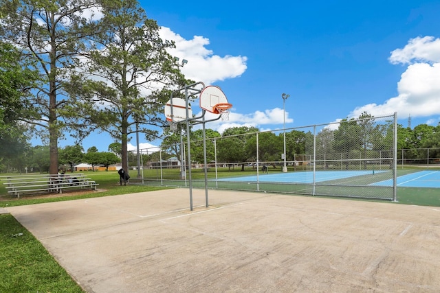 view of sport court featuring fence, community basketball court, and a tennis court