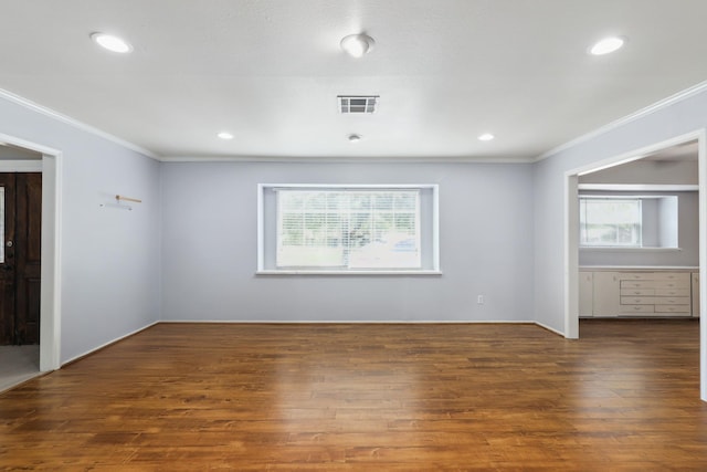 unfurnished bedroom featuring ornamental molding, multiple windows, and visible vents
