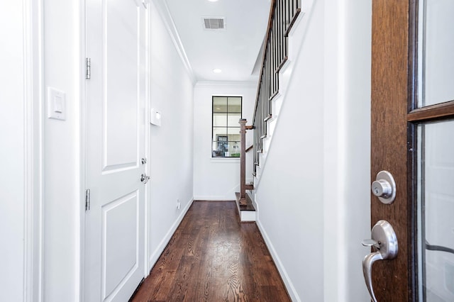 doorway to outside with baseboards, ornamental molding, stairs, dark wood-type flooring, and visible vents