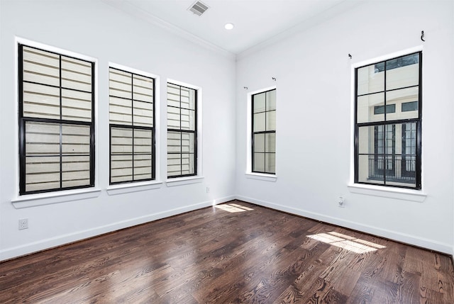 spare room with baseboards, ornamental molding, recessed lighting, visible vents, and wood finished floors