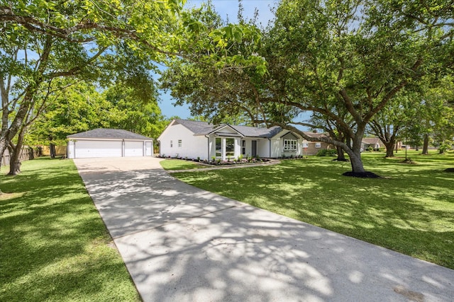 ranch-style home with an outbuilding, a front yard, and a garage