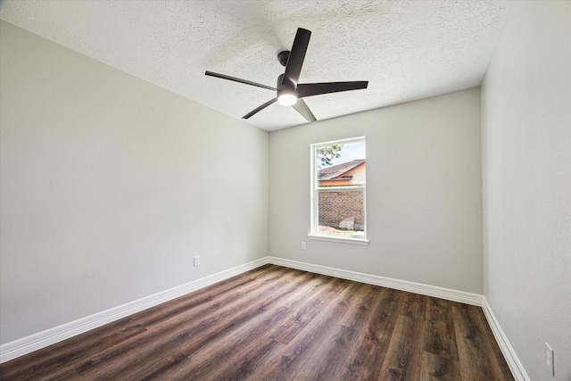 empty room featuring dark wood-style floors, baseboards, a textured ceiling, and ceiling fan