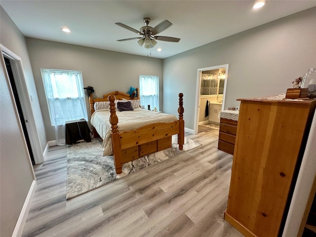 bedroom featuring light wood finished floors, baseboards, and multiple windows