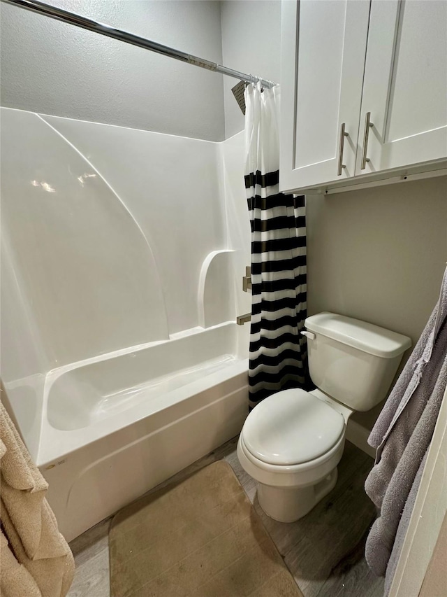 bathroom with toilet and shower / bath combo with shower curtain