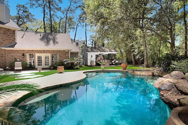 38 Southgate Dr, The Woodlands, TX 77380 - pool featuring a patio area, french doors, and an outdoor structure