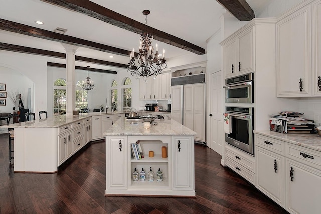 38 Southgate Dr, The Woodlands, TX 77380 - kitchen featuring visible vents, a notable chandelier, paneled refrigerator, a kitchen breakfast bar, and double oven