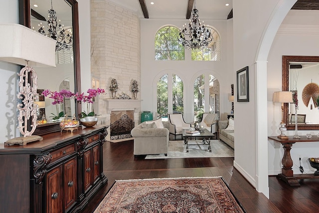 38 Southgate Dr, The Woodlands, TX 77380 - entryway with a towering ceiling, an inviting chandelier, a fireplace, dark wood-type flooring, and arched walkways