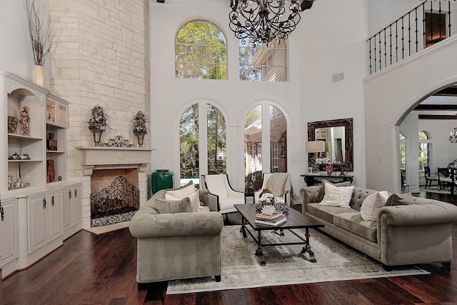 38 Southgate Dr, The Woodlands, TX 77380 - living room featuring visible vents, arched walkways, a notable chandelier, dark wood-style flooring, and a towering ceiling