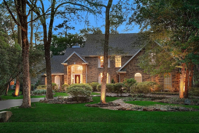 38 Southgate Dr, The Woodlands, TX 77380 - view of front facade with a front yard, brick siding, and a shingled roof