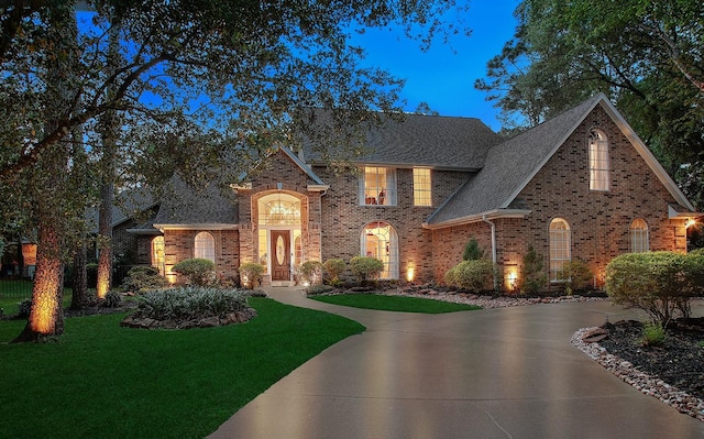 38 Southgate Dr, The Woodlands, TX 77380 - view of front of house featuring a front yard, brick siding, and a shingled roof