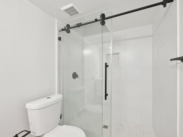 1812 Saxony Ln, Houston, TX 77058 - full bathroom featuring toilet, a shower stall, and a textured wall