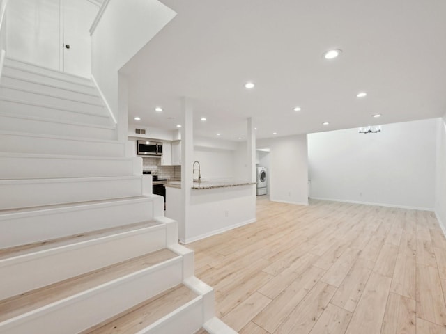 1812 Saxony Ln, Houston, TX 77058 - staircase with washer / clothes dryer, wood finished floors, recessed lighting, and baseboards