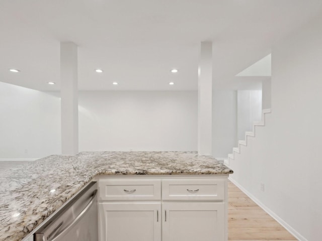 1812 Saxony Ln, Houston, TX 77058 - kitchen with dishwasher, light stone counters, white cabinets, light wood-style floors, and recessed lighting