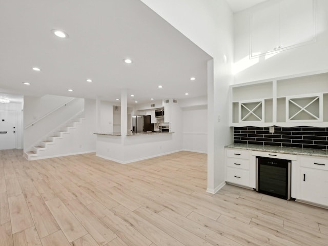 1812 Saxony Ln, Houston, TX 77058 - indoor dry bar with beverage cooler, appliances with stainless steel finishes, tasteful backsplash, light wood-style flooring, and recessed lighting