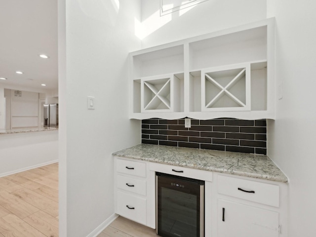 1812 Saxony Ln, Houston, TX 77058 - bar area featuring wine cooler, backsplash, light wood finished floors, recessed lighting, and baseboards