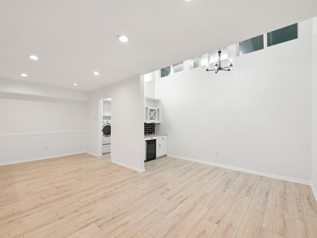 1812 Saxony Ln, Houston, TX 77058 - below grade area with a chandelier, light wood-style flooring, recessed lighting, and washer / clothes dryer
