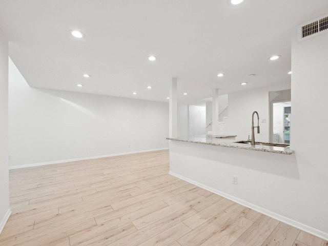 1812 Saxony Ln, Houston, TX 77058 - unfurnished living room featuring light wood finished floors, baseboards, recessed lighting, stairs, and a sink