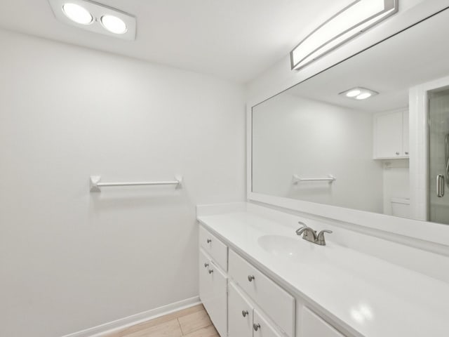 1812 Saxony Ln, Houston, TX 77058 - bathroom with vanity, baseboards, toilet, a shower with door, and wood finished floors