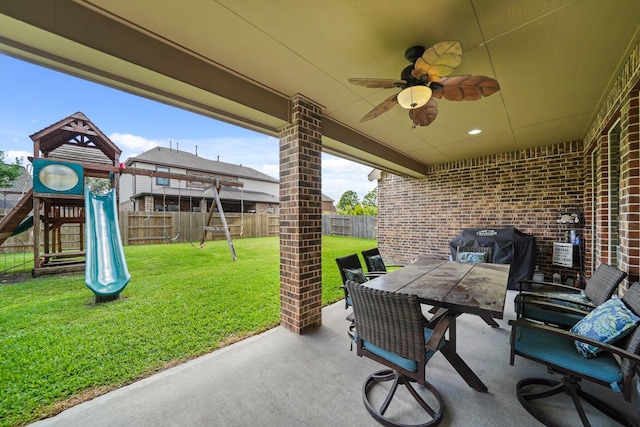 view of patio with a fenced backyard, ceiling fan, outdoor dining area, a grill, and a playground