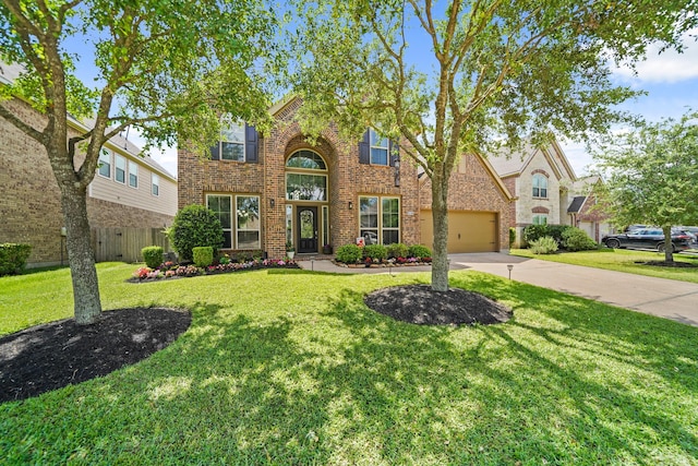 view of front facade with concrete driveway, fence, a front lawn, and brick siding
