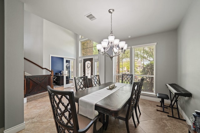 dining room with light tile patterned floors, visible vents, a chandelier, and baseboards