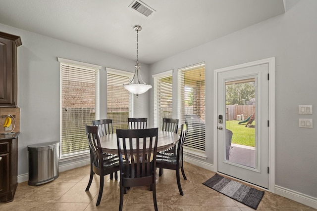 dining room with baseboards, visible vents, and light tile patterned floors