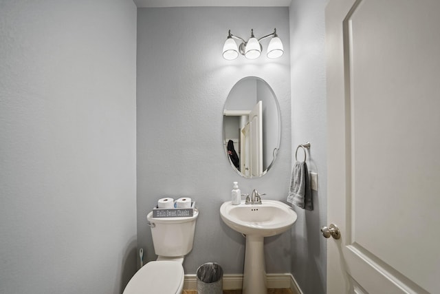 bathroom with toilet and a sink