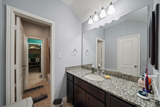 full bath featuring tile patterned floors, vanity, a shower, and lofted ceiling
