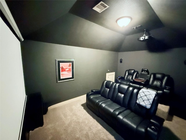 cinema room featuring baseboards, visible vents, carpet floors, and vaulted ceiling