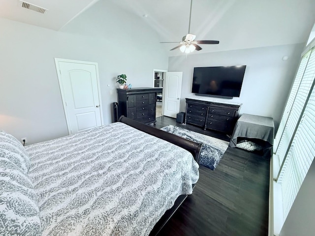 bedroom with vaulted ceiling, visible vents, a ceiling fan, and dark wood-style floors