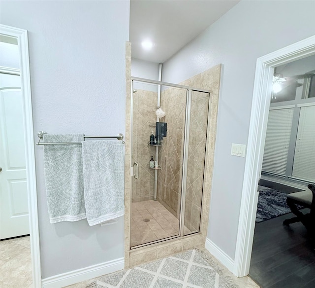 full bath with a stall shower and baseboards